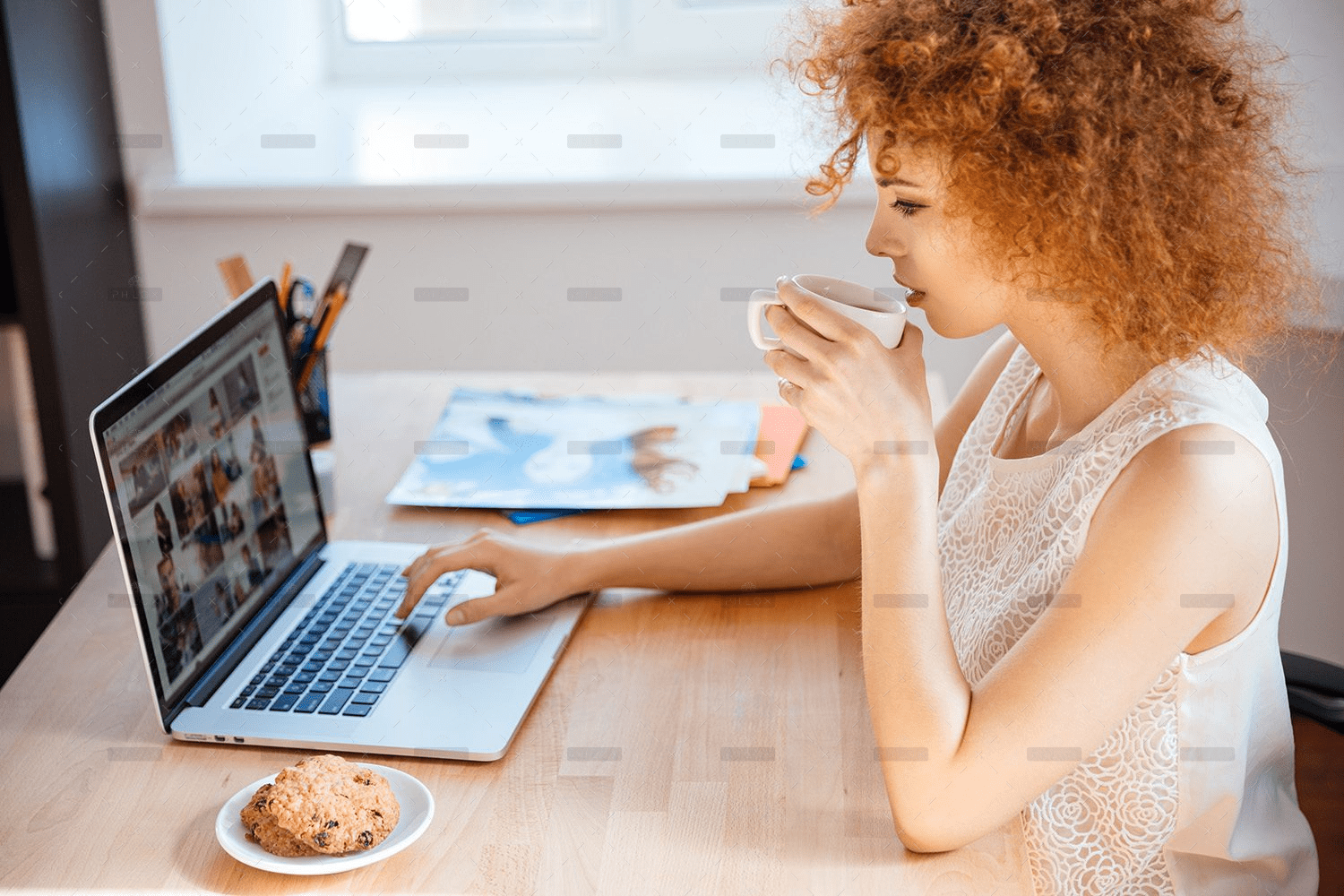 demo-attachment-493-woman-photographer-drinking-coffee-and-working-PJNBP6U